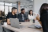 People smiling sitting at an office table